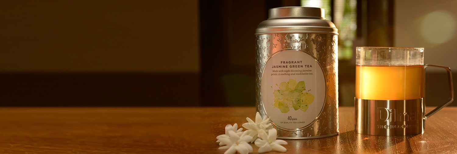 Can of Jasmine Green Tea Next to a Mug of Tea